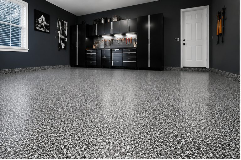 Grey and black flake epoxy garage floor finish with dark cabinetry