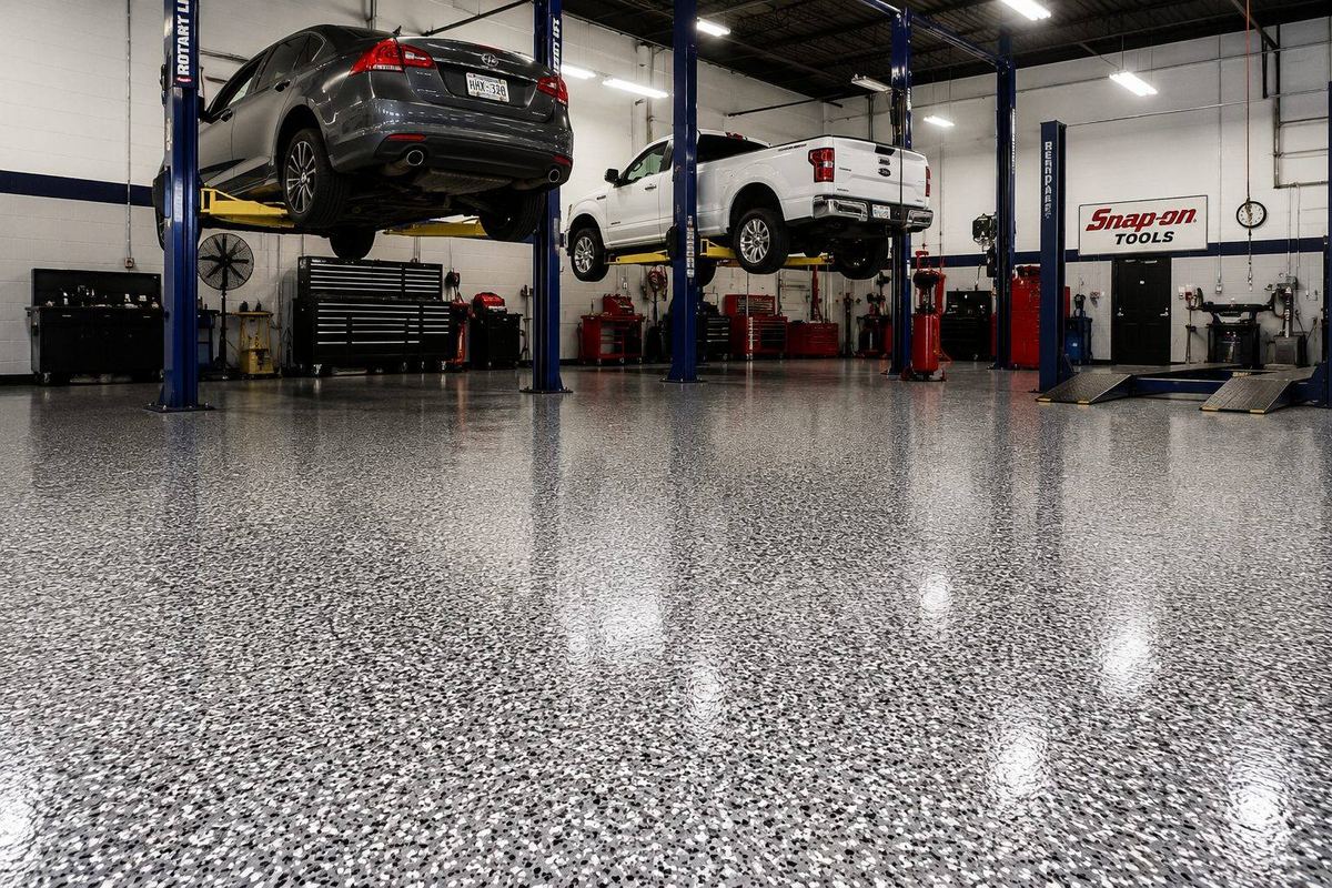 Professional mechanic shop with vehicles on lifts over a flake epoxy coated floor